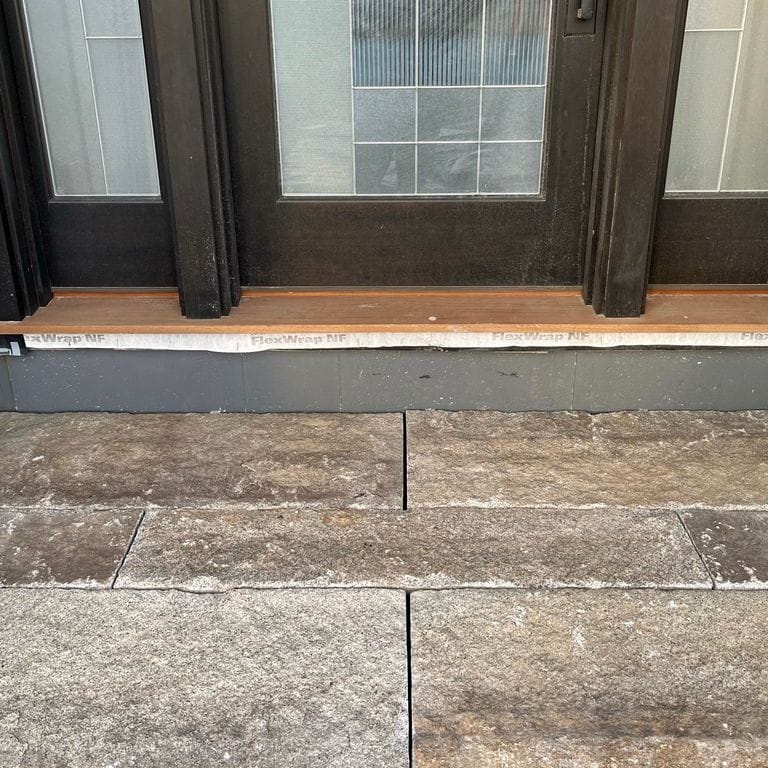 The image shows this material being used in a monolithic steps application. The dominant color shown is gray; with beige, brown, orange/rust, white, tan and cream secondaries. The color mix creates a warm feeling. Regular color pattern.