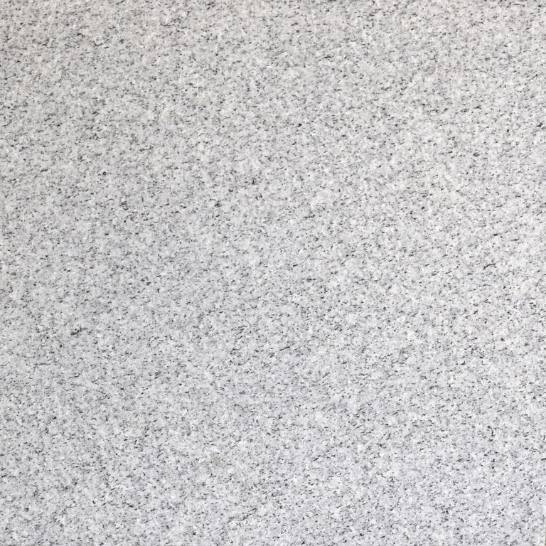 Close-up image for Midnight Gray Granite. The surface finish shown is flamed. Dominant colors shown are gray and white; with a beige secondary. The color mix creates a cool feeling. Fine speckled color pattern. Contains some mica.