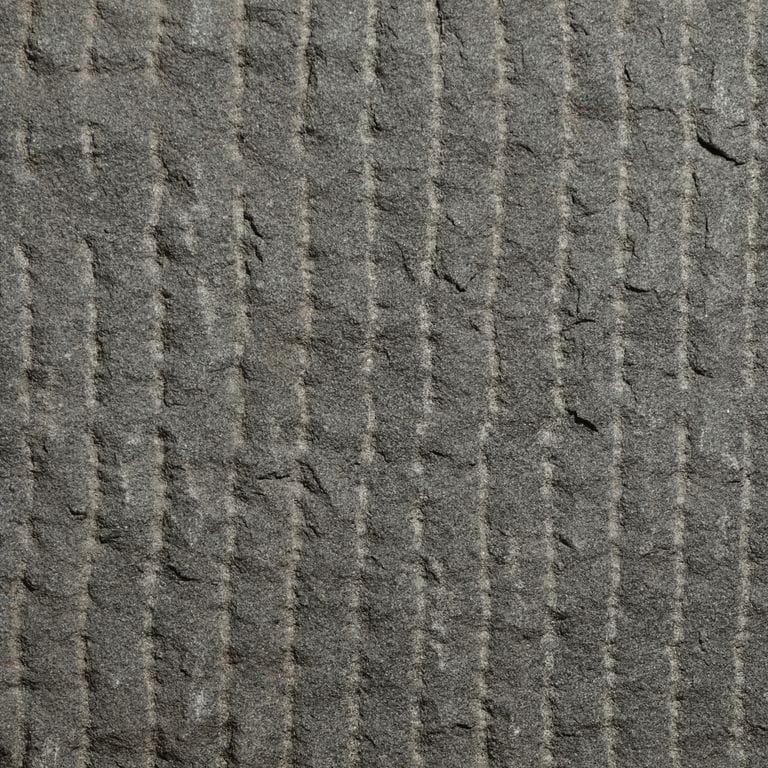 Color/Finish variation image for Sugus Black Sandstone. The surface finish shown is point stalk. Dominant colors shown are black and gray. The color mix creates a cool feeling.