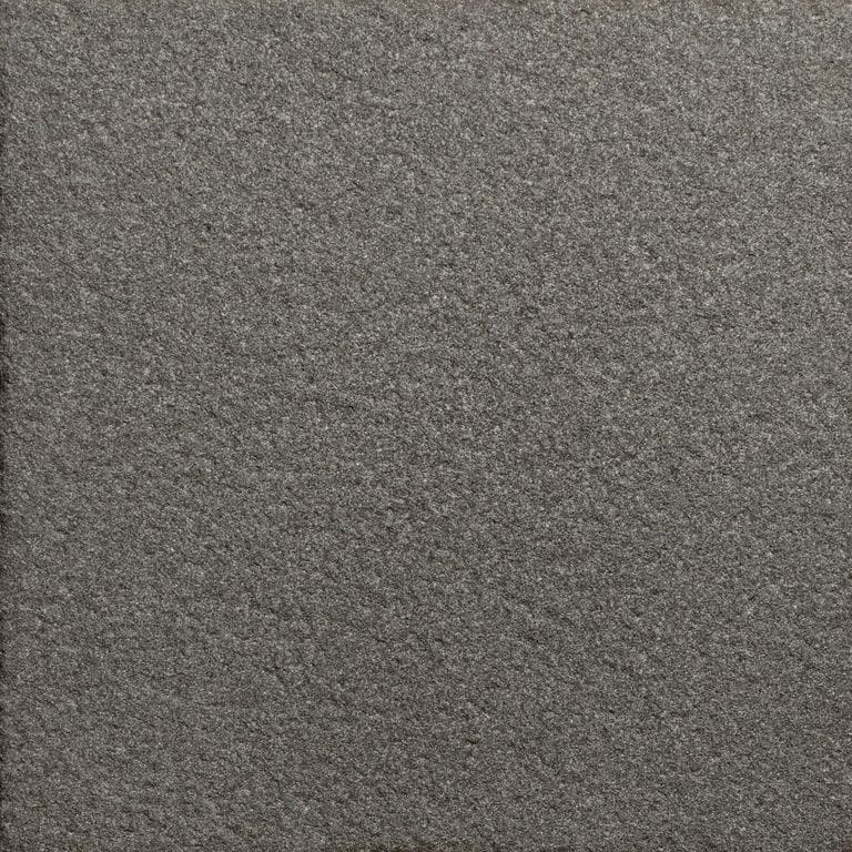 Color/Finish variation image for Sugus Black Sandstone. The surface finish shown is sand blasted. Dominant colors shown are black and gray. The color mix creates a cool feeling.