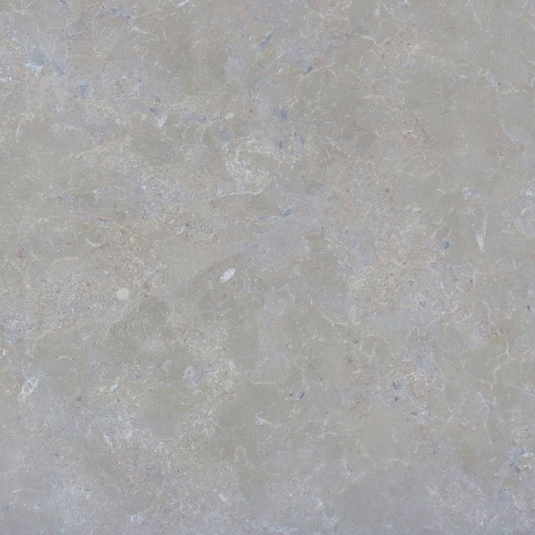 Color/Finish variation image for Estrema Light Limestone. The surface finishes shown are brushed and flamed. The dominant color shown is gray; with beige and blue secondaries. Exhibits "movement" and the color mix creates a cool feeling. Blotched, swirled and cloudy color patterns.