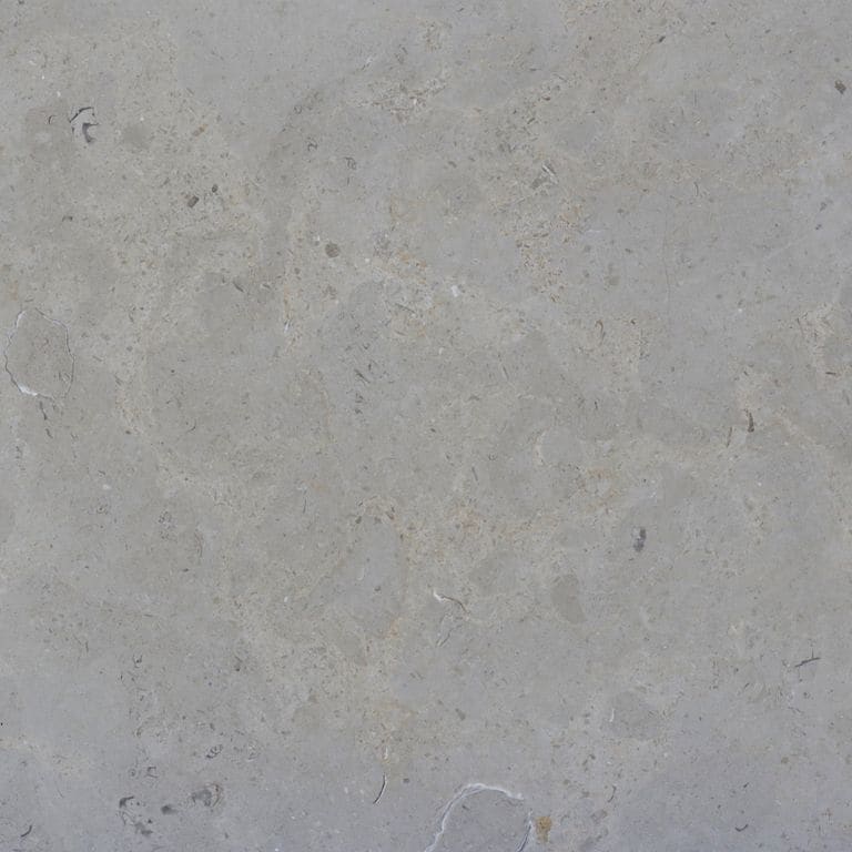 Color/Finish variation image for Estrema Light Limestone. The surface finish shown is honed. The dominant color shown is gray. Exhibits "movement" and the color mix creates a cool feeling. Blotched and cloudy color patterns.