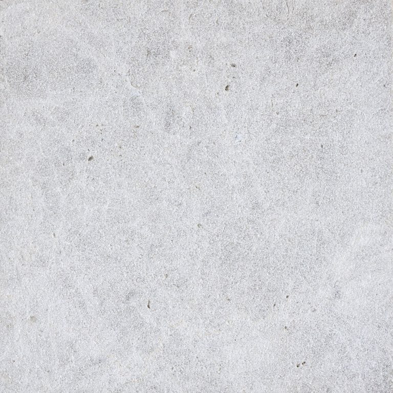 Color/Finish variation image for Limestone - Dalmatian. The surface finish shown is sand blasted. Dominant colors shown are gray and white; with beige and cream secondaries. The color mix creates a cool feeling. Cloudy color pattern.