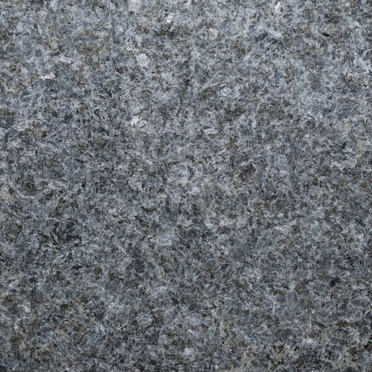 Color/Finish variation image for Superior Northern Granite. The surface finish shown is flamed. Dominant colors shown are black and gray. The color mix creates a cool feeling. Blotched and coarse speckled color patterns.
