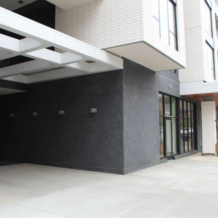 Application image for Superior Northern Granite. The image shows this material being used for full bed veneer and thin veneer. The surface finish shown is leathered. Dominant colors shown are black, blue and gray. The color mix creates a cool feeling. Solid color pattern.
