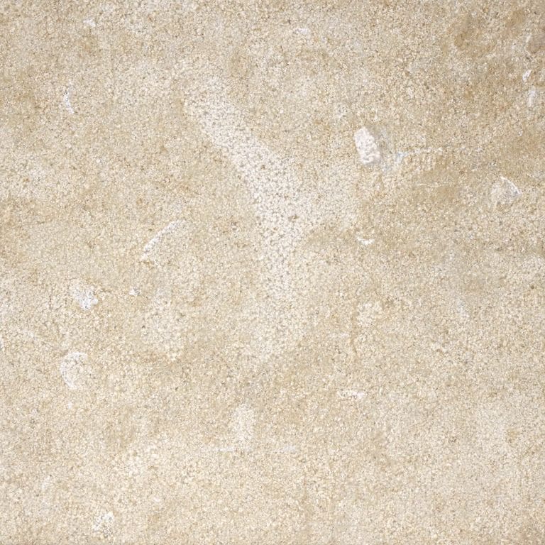 Best close-up image for Giallo Medici Limestone. The surface finish shown is fine bush hammered. Dominant colors shown are beige and tan; with brown, orange/rust, white and cream secondaries. The color mix creates a warm feeling. Random color pattern. Contains mineral inclusions.