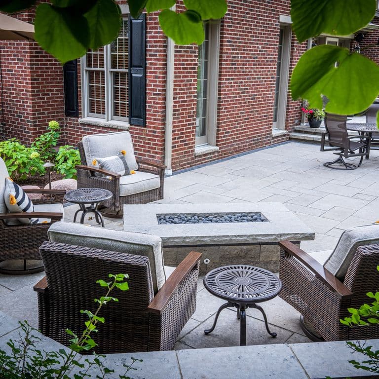 Application image for Madison Limestone. The image shows this material being used in a patio pavers application. The surface finish shown is flamed. The dominant color shown is gray. The color mix creates a cool feeling.