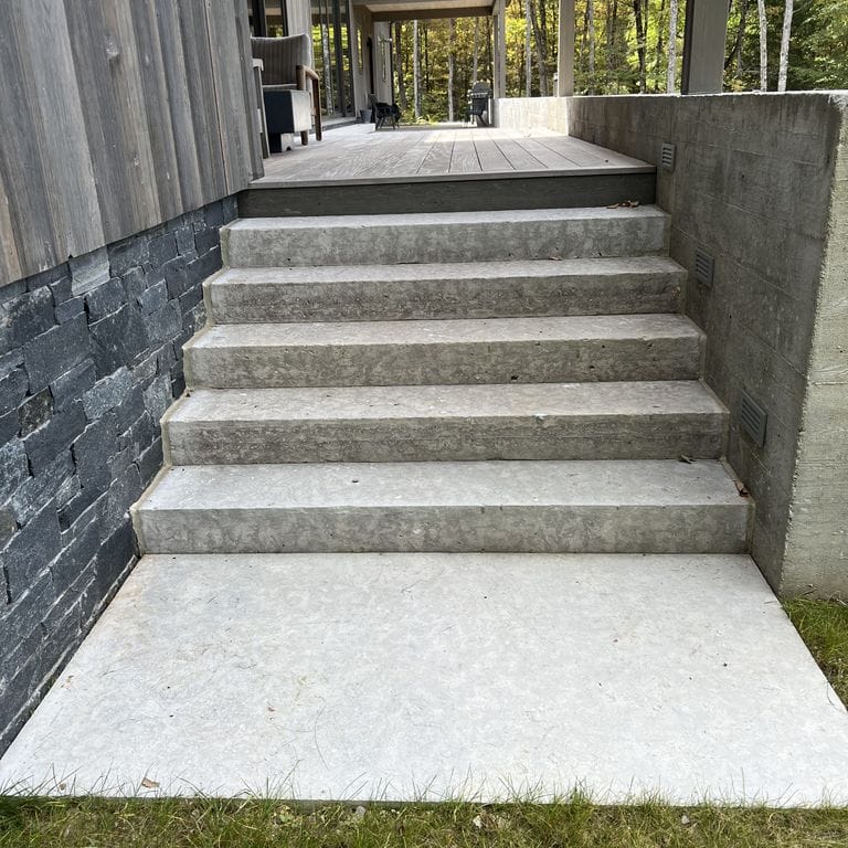 Application image for Limestone - Madison. The image shows this material being used in a monolithic steps application. The dominant color shown is gray. The color mix creates a warm feeling.