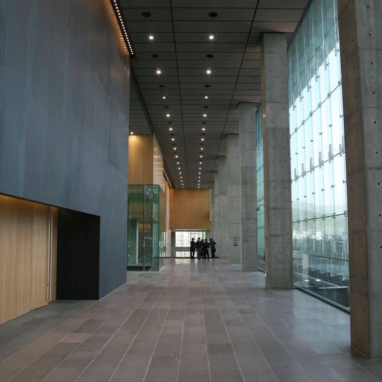 Feature image for Basaltina Basalt. The image shows this material being used for interior floor and thin veneer. The surface finish shown is polished. Dominant colors shown are gray and purple. The color mix creates a cool feeling. Solid and fine speckled color patterns.