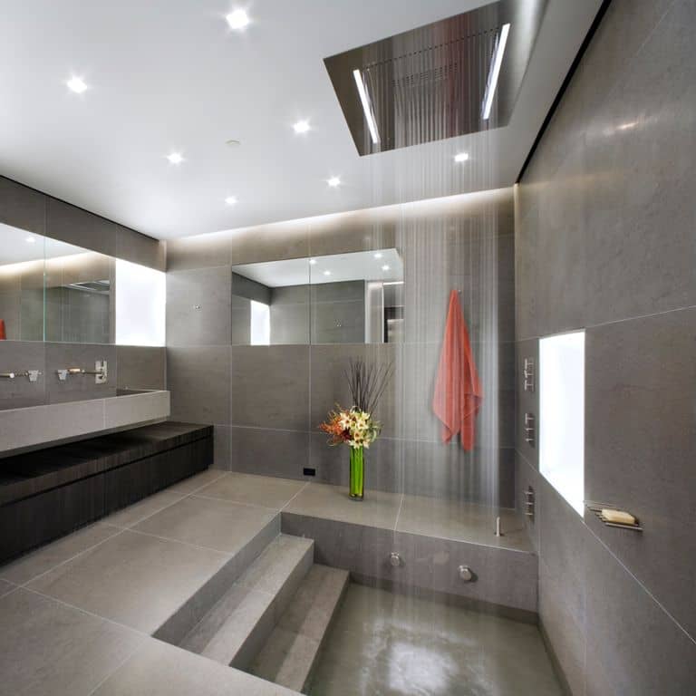 Application image for Basaltina Basalt. The image shows this material being used for interior floor, sinks, bath tub &amp; shower and thin veneer. The surface finish shown is honed. The dominant color shown is gray. The color mix creates a warm feeling. Solid and regular color patterns.