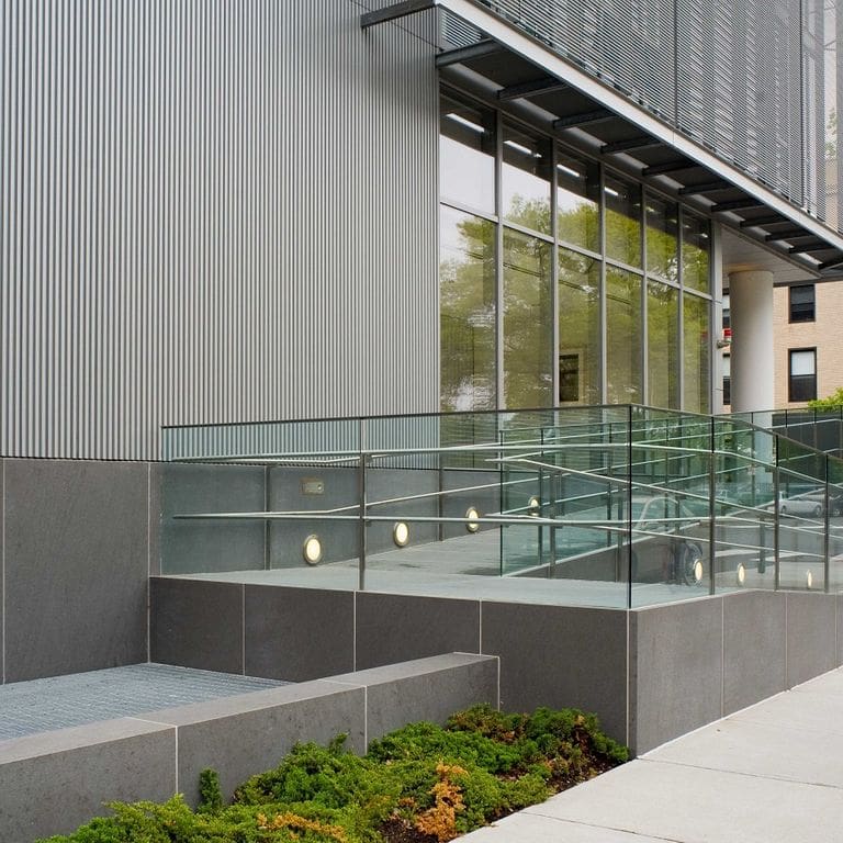 Application image for Basaltina Basalt. The image shows this material being used for path pavers and thin veneer. The surface finish shown is honed. The dominant color shown is gray. The color mix creates a warm feeling. Solid color pattern.