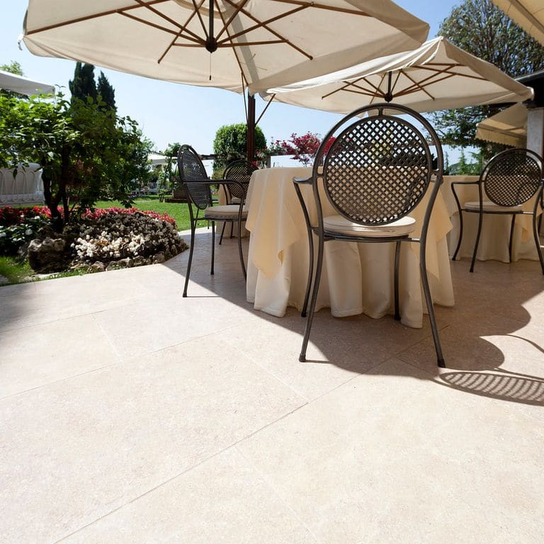 Application image for Veneto Beige Limestone - Pavers. The image shows this product being used in a patio pavers application. The surface finish shown is . Dominant colors shown are beige and cream. The color mix creates a warm feeling.