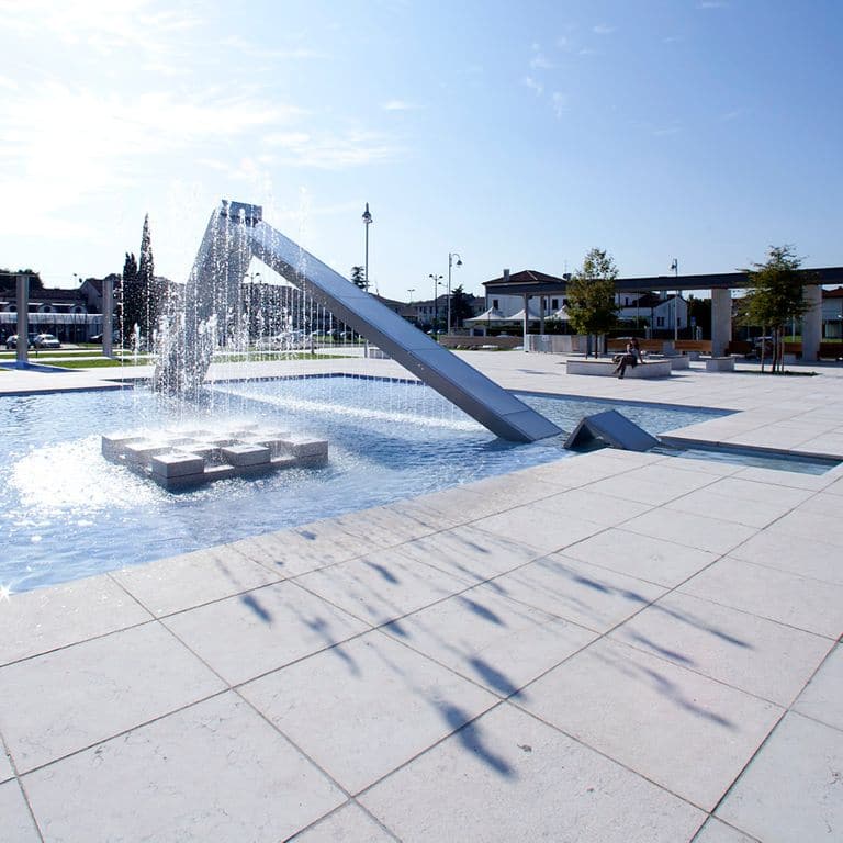 Application image for Veneto Beige Limestone - Pavers. The image shows this product being used in a public area application. The surface finish shown is flamed. Dominant colors shown are beige and cream. The color mix creates a cool feeling.