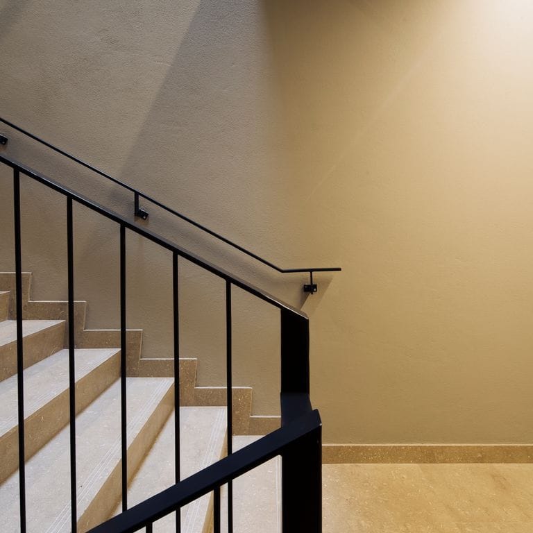 Application image for Veneto Olivo Limestone - Steps &amp; Treads. The image shows this product being used for landings and treads. The surface finish shown is honed. Dominant colors shown are beige and tan. The color mix creates a warm feeling.