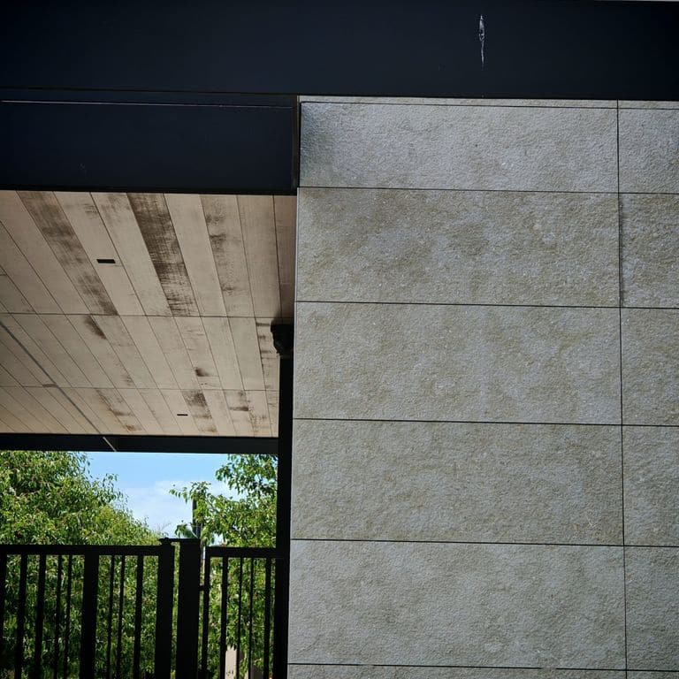 Application image for Veneto Olivo Limestone - Veneer. The image shows this product being used in a full bed veneer application. The surface finish shown is . Dominant colors shown are gray and tan.