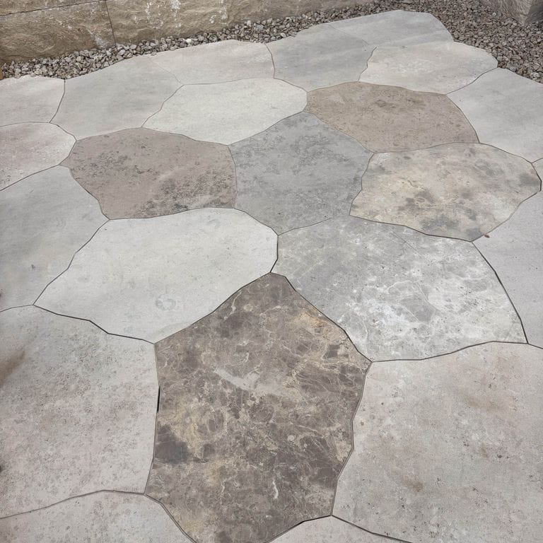 Application image for Bavarian Dolomite Gray Limestone - Irregular Pavers - Waterjet Cut Edge. The image shows this product being used in a patio pavers application. The dominant color shown is gray. The color mix creates a warm feeling.