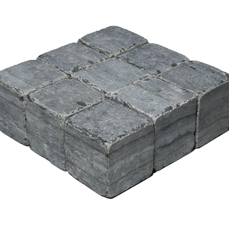 Feature image for Black Schist Cobblestone - Tumbled Cubes. The surface finish shown is tumbled. Dominant colors shown are black and gray. The color mix creates a cool feeling.