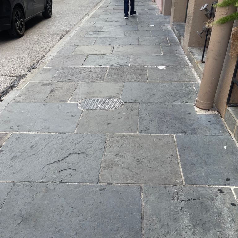 Application image for Reclaimed Bluestone Hand Cut Pavers. The image shows this product being used for path pavers and public area. The surface finish shown is natural cleft. Dominant colors shown are blue and gray. The color mix creates a warm feeling.