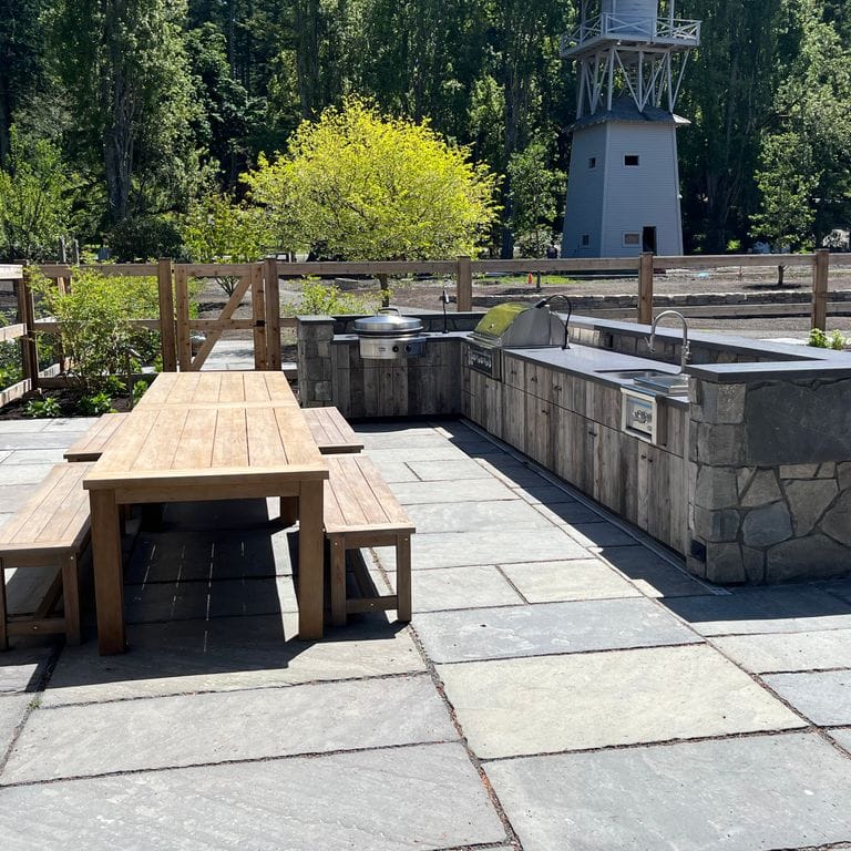 Application image for Reclaimed Bluestone Hand Cut Pavers. The image shows this product being used in a patio pavers application. The surface finish shown is natural cleft. The dominant color shown is gray.
