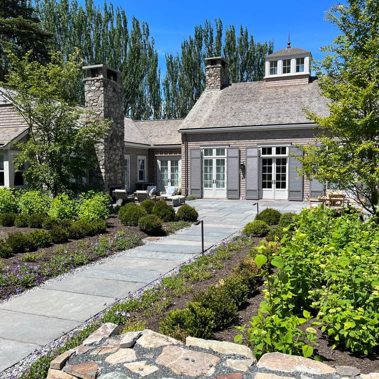 Application image for Reclaimed Bluestone Hand Cut Pavers. The image shows this product being used in a path pavers application. The surface finish shown is natural cleft. The dominant color shown is gray. The color mix creates a cool feeling.