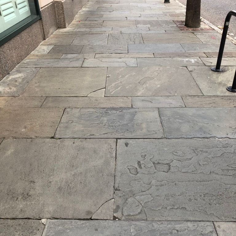 Application image for Reclaimed Bluestone Hand Cut Pavers. The image shows this product being used in a path pavers application. The surface finish shown is natural cleft. The dominant color shown is gray. The color mix creates a warm feeling.