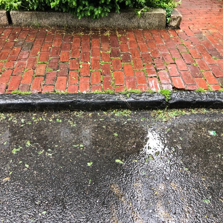 Application image for Reclaimed Bluestone Curbstone - Edging. The image shows this product being used in a landscape curbing &amp; edging application. The surface finish shown is . The dominant color shown is gray. The color mix creates a warm feeling.