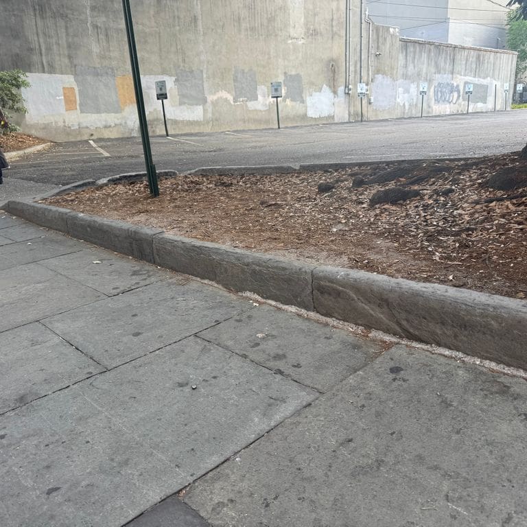 Application image for Reclaimed Bluestone Curbstone - Edging. The image shows this product being used in a landscape curbing &amp; edging application. The surface finish shown is . The dominant color shown is gray.