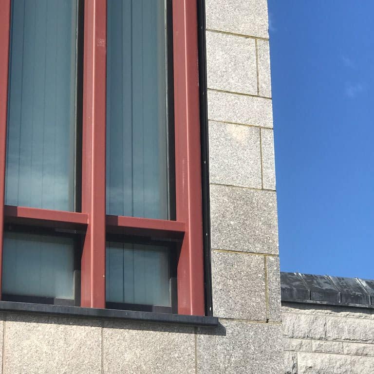 Application image for Deer Isle Granite - Cut to Size Veneer. The image shows this product being used in a full bed veneer application. The dominant color shown is gray.