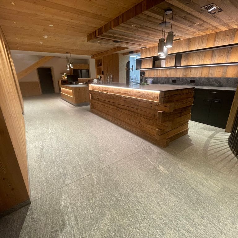 Application image for Pietra Italia Gray Gneiss - Interior Flooring. The image shows this product being used in an interior floor application. The surface finish shown is . The dominant color shown is gray. The color mix creates a cool feeling.