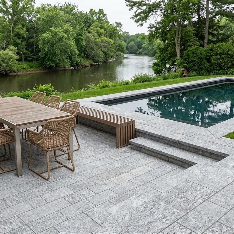 Application image for Pietra Italia Gray Gneiss - Pool Deck. The image shows this product being used for pool coping, patio pavers and pool deck pavers. The surface finish shown is sand blasted. The dominant color shown is gray. The color mix creates a warm feeling.