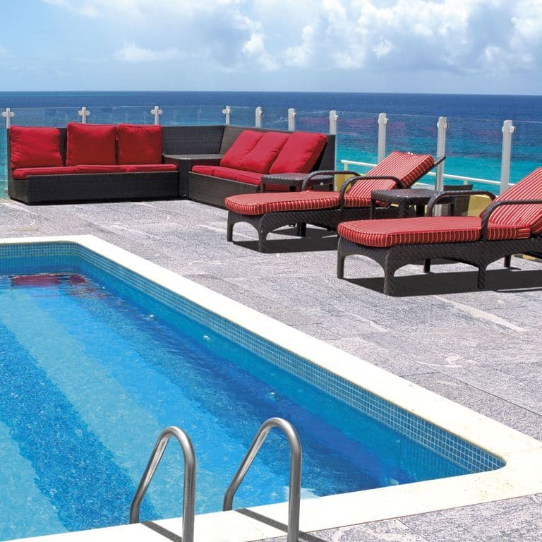 Application image for Pietra Italia Gray Gneiss - Pool Deck. The image shows this product being used in a pool deck pavers application. The dominant color shown is gray. The color mix creates a cool feeling.