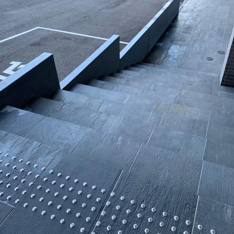 Application image for Black Schist - Steps, Treads &amp; Landings. The image shows this product being used in a treads application. The surface finish shown is honed. Dominant colors shown are black and gray. The color mix creates a cool feeling.