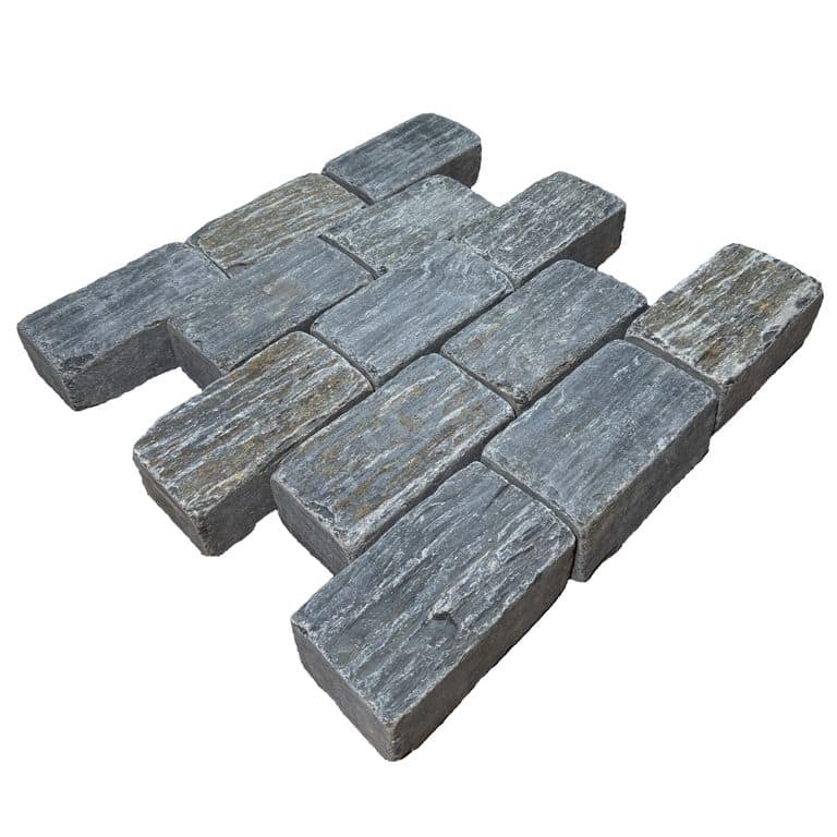 Feature image for Black Schist Cobblestone - Rectangle - Natural Cleft &amp; Tumbled. The surface finish shown is natural cleft. Dominant colors shown are black, gray and orange/rust. The color mix creates a cool feeling.