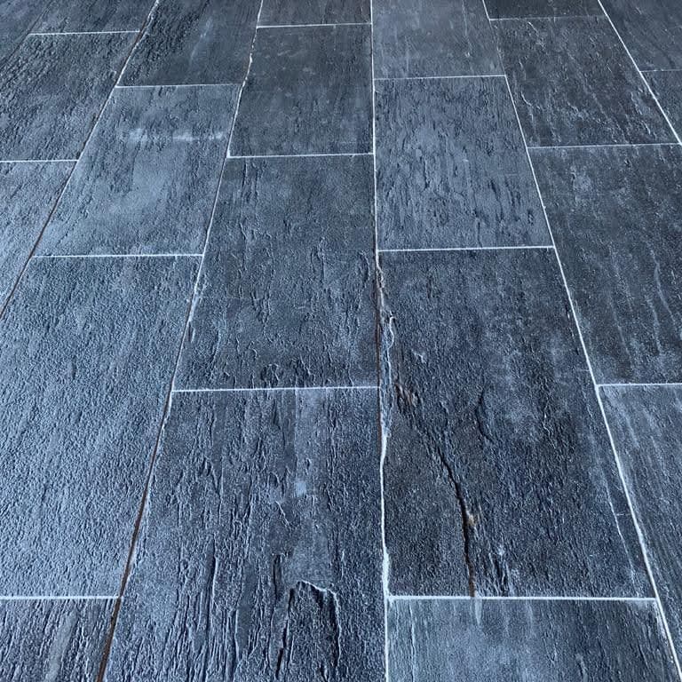 Best close-up image for Black Schist - Interior Flooring. The image shows this product being used in an interior floor application. Dominant colors shown are black and gray. The color mix creates a cool feeling.