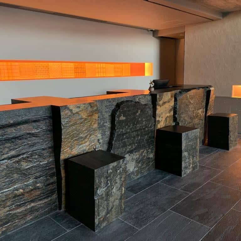 Application image for Black Schist - Interior Flooring. The image shows this product being used in an interior floor application. Dominant colors shown are black and gray. The color mix creates a cool feeling.