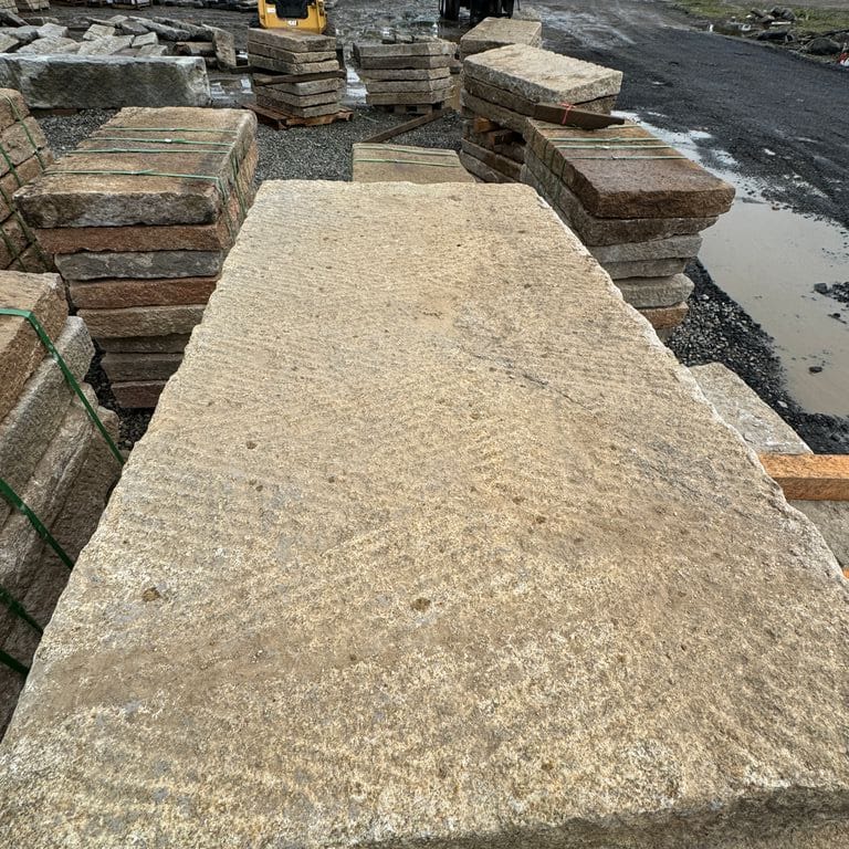 Best close-up image for Reclaimed Rustic Golden Granite Planks 4x2' Planks. The surface finish shown is split-face. Dominant colors shown are brown and tan. The color mix creates a warm feeling.
