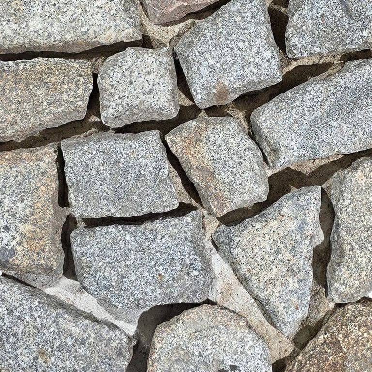 Color/Finish variation image for Reclaimed Polygonal Granite Cobblestones - Worn Surface. The surface finish shown is . Dominant colors shown are gray and tan. The color mix creates a warm feeling.