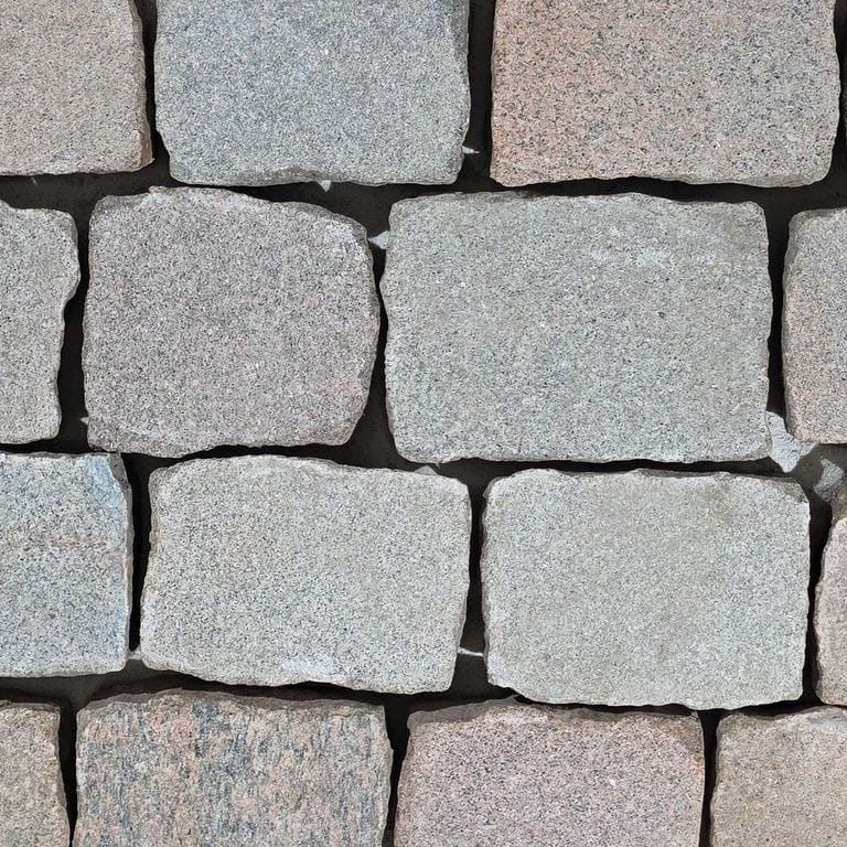 Color/Finish variation image for Reclaimed Multicolor Granite Cobblestones - Flamed Surface. The surface finish shown is flamed. Dominant colors shown are gray and pink. The color mix creates a cool feeling.