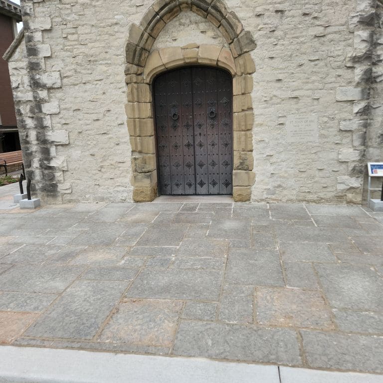 Application image for Madison Full Color Limestone - Pavers. The image shows this product being used in a patio pavers application. The surface finish shown is flamed. Dominant colors shown are gray and pink.