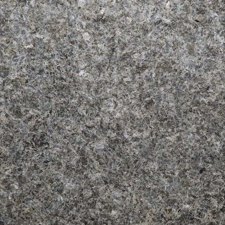Color/Finish variation image for Superior Northern Granite - Pavers. The surface finish shown is flamed. Dominant colors shown are black and gray. The color mix creates a cool feeling. Blotched and coarse speckled color patterns.
