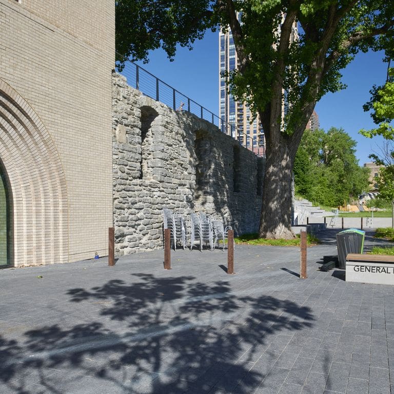 Feature image for Superior Northern Granite - Pavers. The image shows this product being used in a public area application. Dominant colors shown are black and gray.