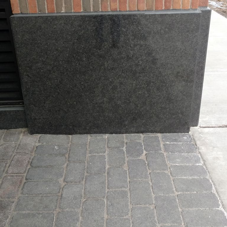 Application image for Superior Northern Granite - Cobblestones. The surface finish shown is tumbled. Dominant colors shown are black and gray.