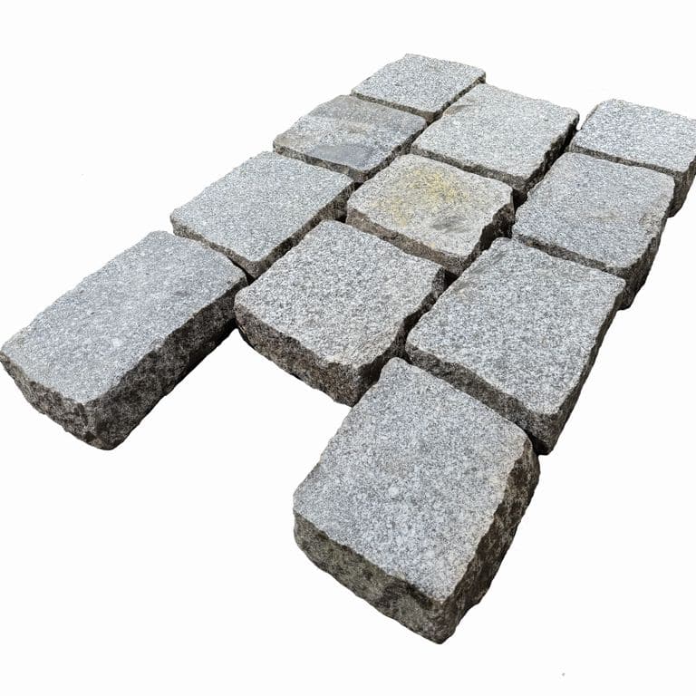 Feature image for Reclaimed Berlin Granite Cobblestones - Flat Surface. The surface finish shown is sawn. The dominant color shown is gray. The color mix creates a cool feeling.