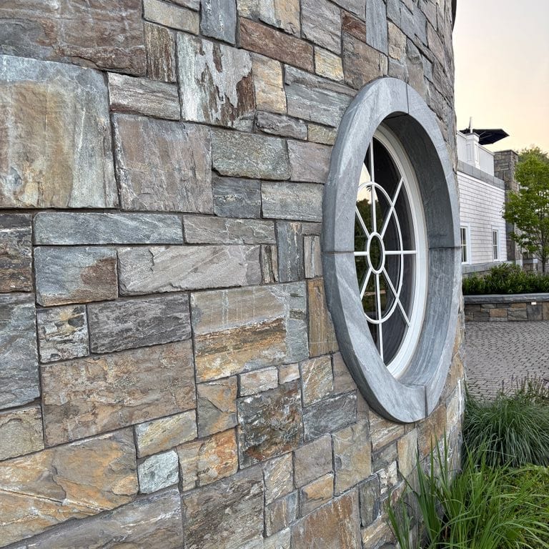 Best close-up image for Mystic Mountain Granite - Natural Surface Veneer. The image shows this product being used for full bed veneer and thin veneer. The surface finish shown is natural. The dominant color shown is gray. The color mix creates a warm feeling.