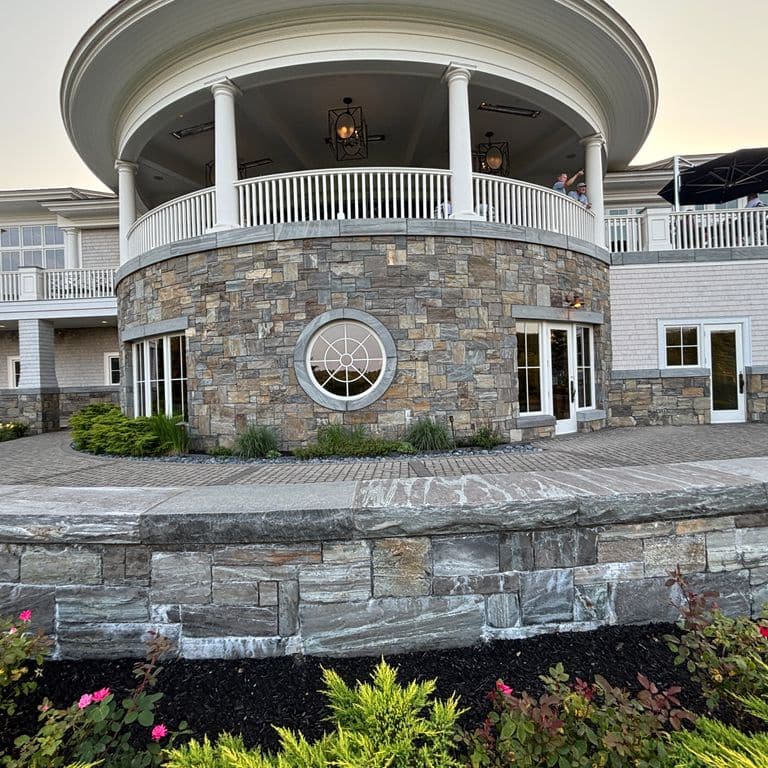 Feature image for Mystic Mountain Granite - Natural Surface Veneer. The image shows this product being used for full bed veneer and thin veneer. The surface finish shown is natural. The dominant color shown is gray. The color mix creates a warm feeling.