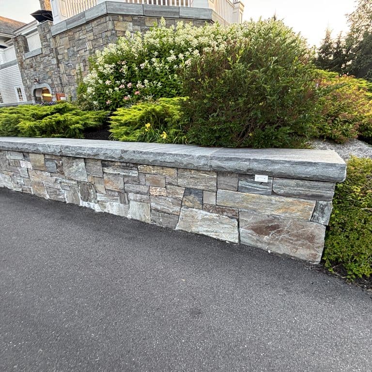 Application image for Mystic Mountain Granite - Natural Surface Veneer. The image shows this product being used for full bed veneer and thin veneer. The surface finish shown is natural. The dominant color shown is gray. The color mix creates a warm feeling.