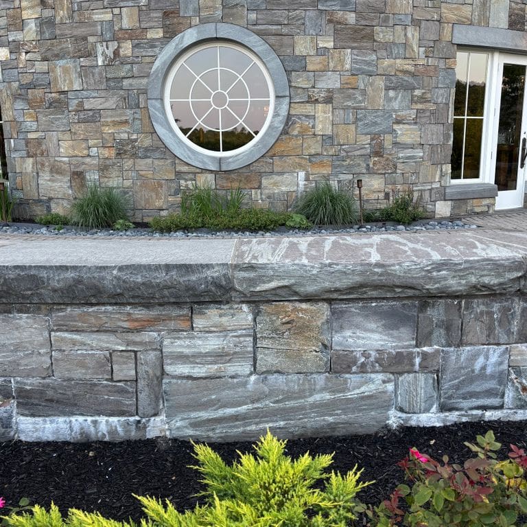 Application image for Mystic Mountain Granite - Natural Surface Veneer. The image shows this product being used for full bed veneer and thin veneer. The surface finish shown is natural. The dominant color shown is gray. The color mix creates a warm feeling.