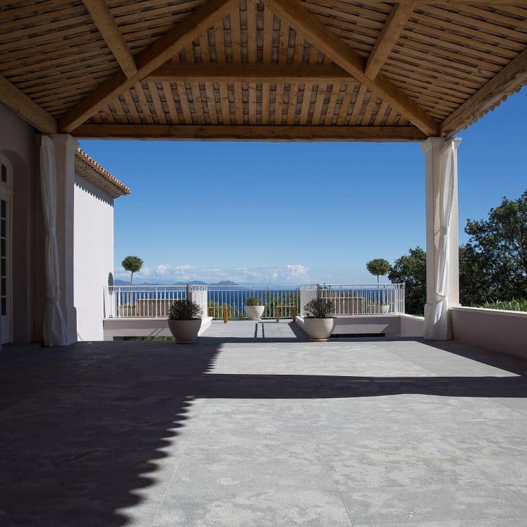 Feature image for Titanium Gray Limestone - Pavers. The image shows this product being used in a patio pavers application. The dominant color shown is gray. The color mix creates a cool feeling.