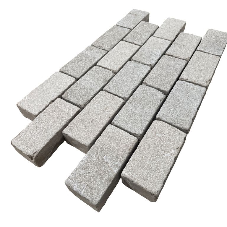 Feature image for Amaza Estrema Limestone Cobblestone - Rectangle - Bush Hammered &amp; Tumbled. The surface finish shown is . Dominant colors shown are gray and tan. The color mix creates a warm feeling.