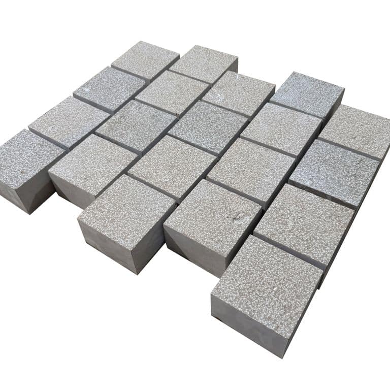 Feature image for Amaza Estrema Limestone Cobblestone - Square - Bush Hammered. The surface finish shown is bush hammered. Dominant colors shown are gray and tan. The color mix creates a warm feeling.